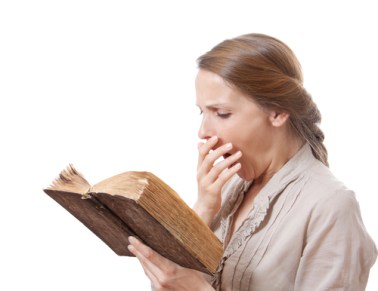 yawning girl reading a boring book