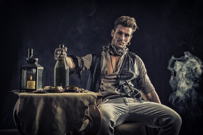 Good Looking Young Man in Pirate Fashion Outfit Sitting next to